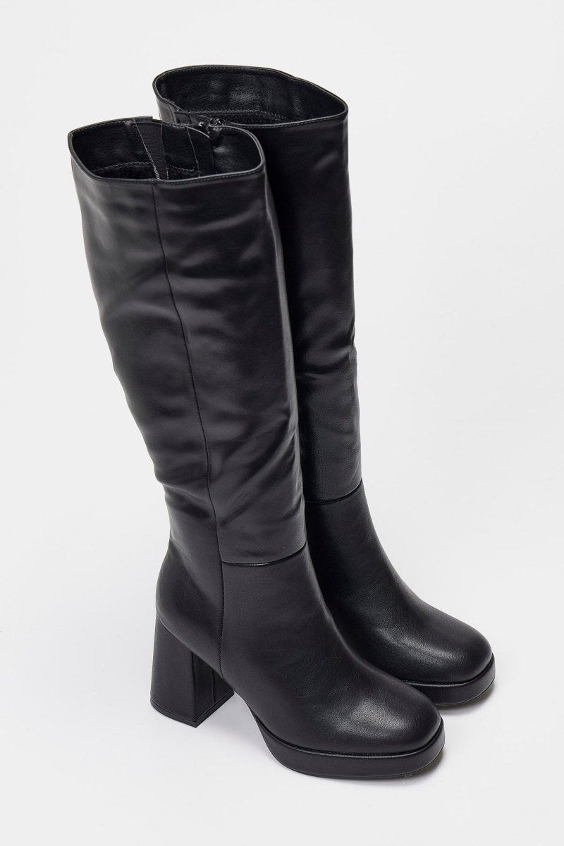 Pair of black leather knee-high platform boots with block heels and side zip, front view