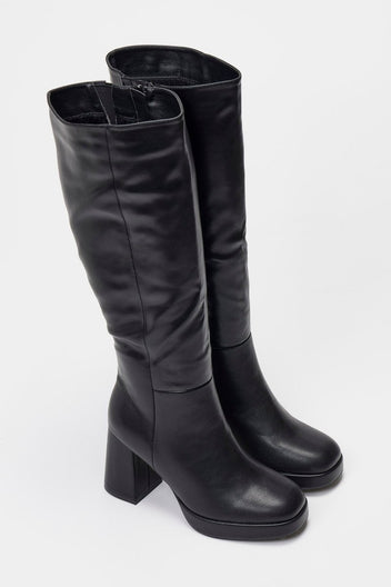 Pair of black leather knee-high platform boots with block heels and side zip, front view