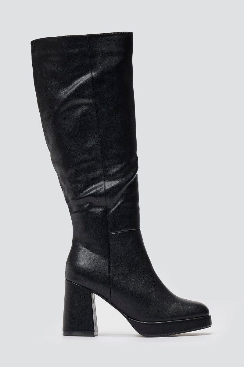 Black leather knee-high platform boot with block heel and slouchy shaft, side view