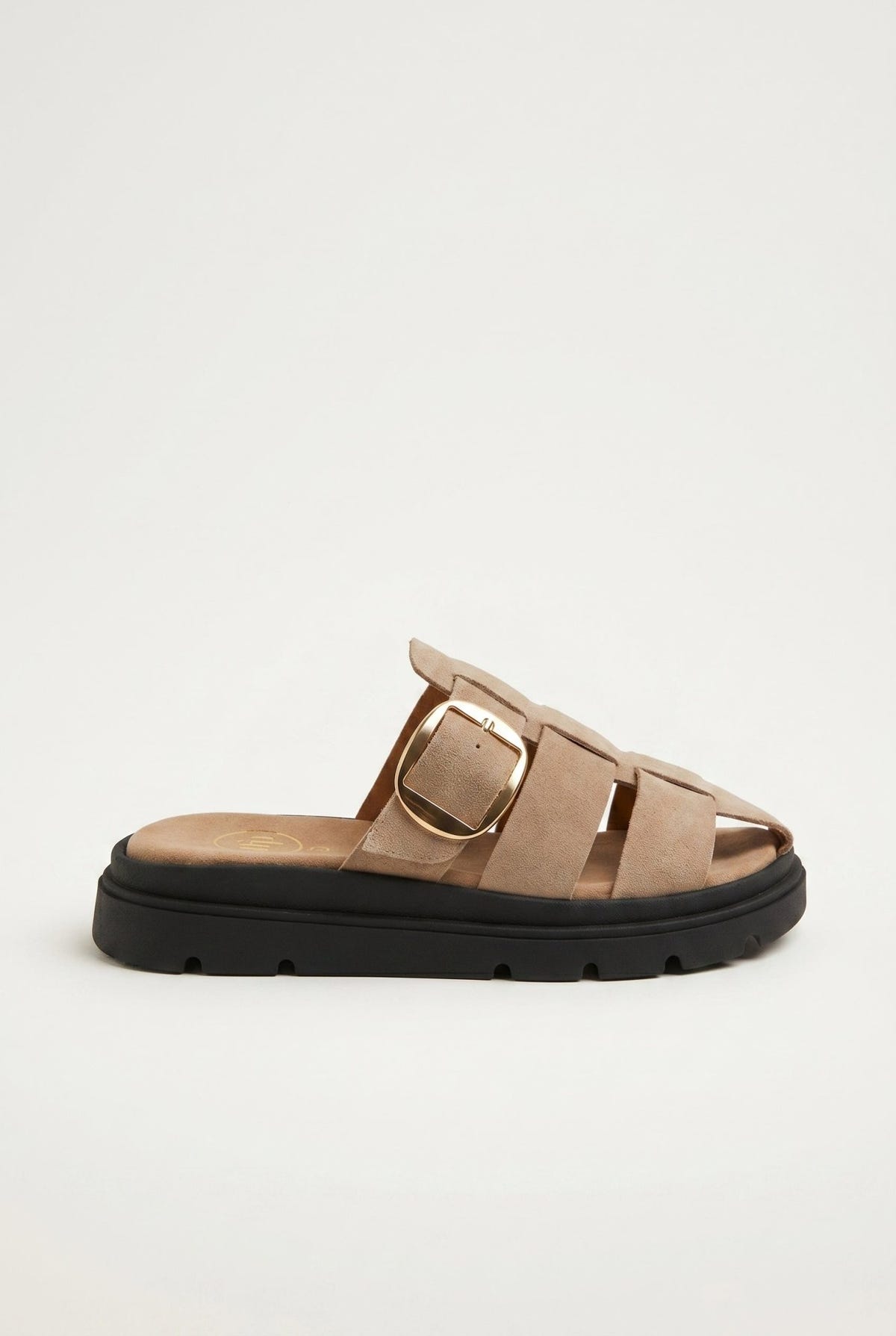 Beige suede fisherman slide sandal with caged straps, gold buckle and chunky black sole, side view