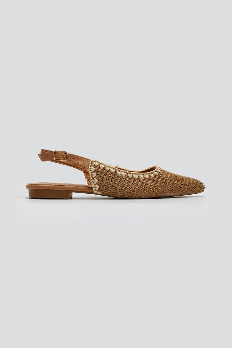 Tan woven raffia pointed toe flat slingback with ankle strap and thin sole, side view