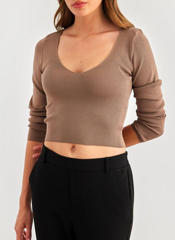 Close-up of brown scoop V-neck long sleeve knit top on model, front view of the neckline