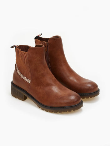 Pair of camel ankle boots with elastic side panel, gold glitter trim and chunky lug sole, three-quarter view