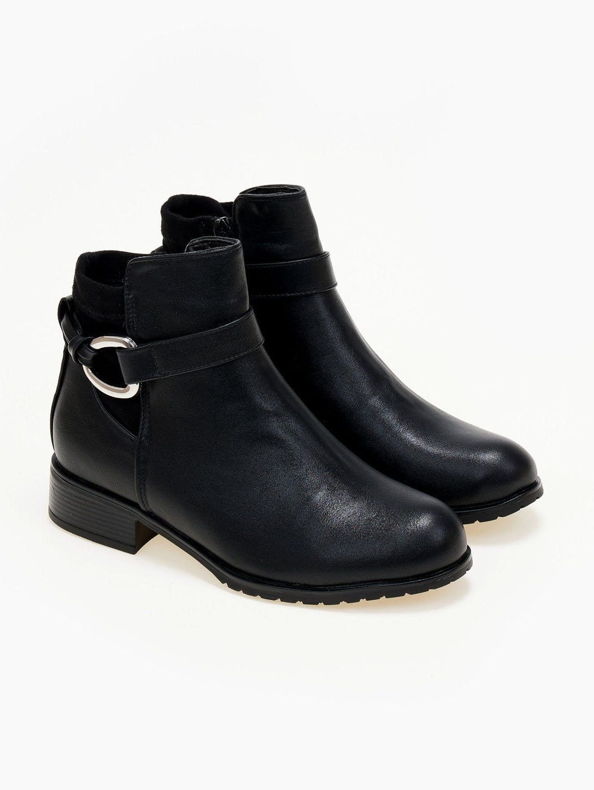 Pair of black faux leather ankle boots with ankle strap, silver ring buckle and low heel, three-quarter view