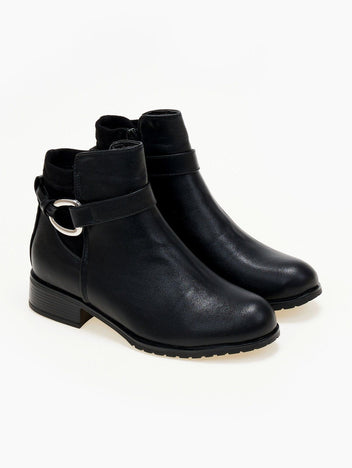 Pair of black faux leather ankle boots with ankle strap, silver ring buckle and low heel, three-quarter view