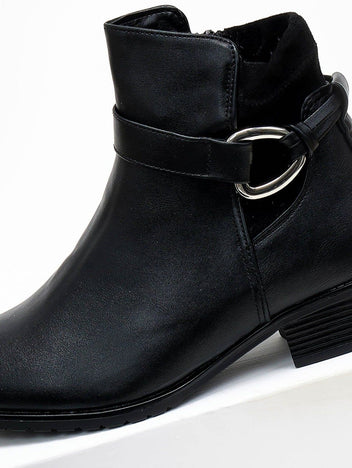 Black faux leather ankle boot with strap, silver ring buckle and side zip, close-up of buckle and cutout detail