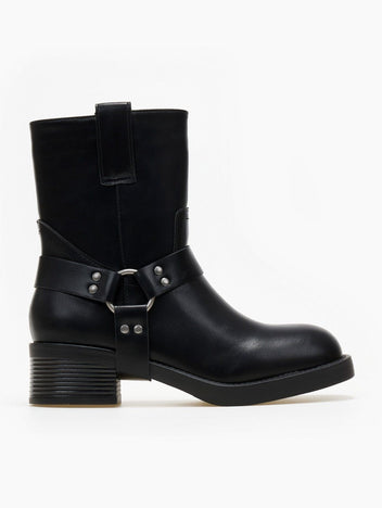 Black faux leather mid-calf biker boot with harness ring strap, studs and block heel, flat side view