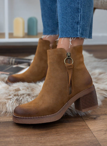 Camel suede ankle boots with ring pull side zipper and block heel, worn on model, front angled view