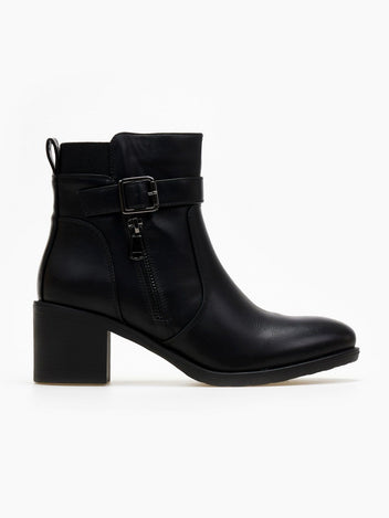 Block heel ankle boots with buckle strap and decorative outer zipper in black faux leather, side view