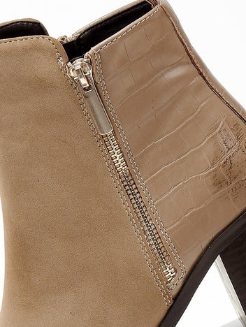 Close-up of taupe suede ankle boot showing gold side zip and croc-embossed leather panel stitching