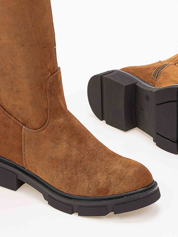 Tan faux suede boot with stitched seam, rounded toe and chunky black lug sole, close-up of toe and sole detail