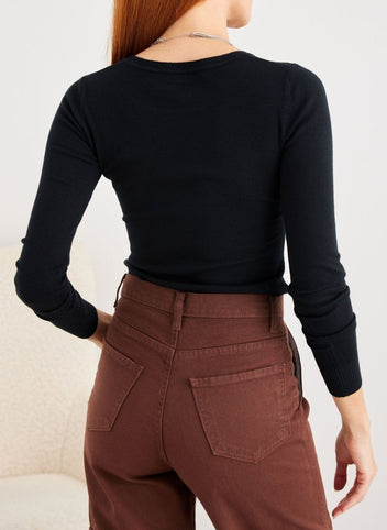 Brown wide leg cargo pants with back pockets and relaxed fit, close-up back view worn on model