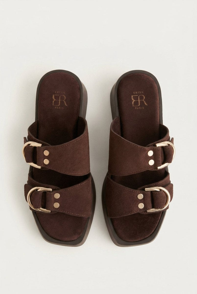 Pair of brown suede platform sandals with two straps, gold D-ring buckles and rivets, seen from above showing square toes