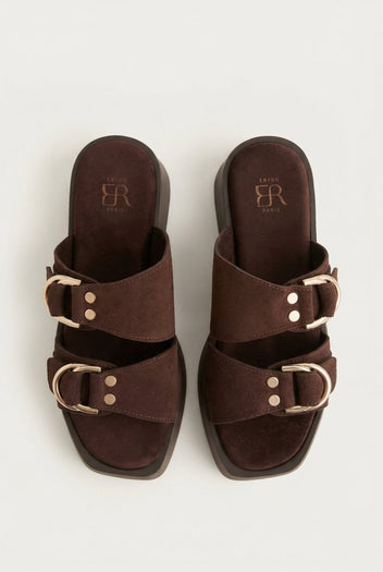 Pair of brown suede platform sandals with two straps, gold D-ring buckles and rivets, seen from above showing square toes