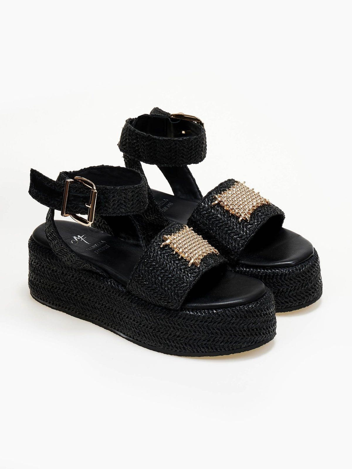 Black woven raffia platform sandals with ankle buckle strap and gold mesh patch, three-quarter view
