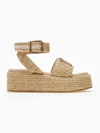 Natural raffia platform sandal with buckled ankle strap and wide front strap, side view