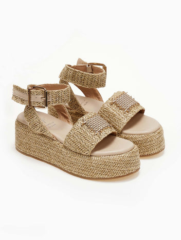 Natural raffia platform sandals with ankle buckle strap and gold mesh detail, three-quarter view