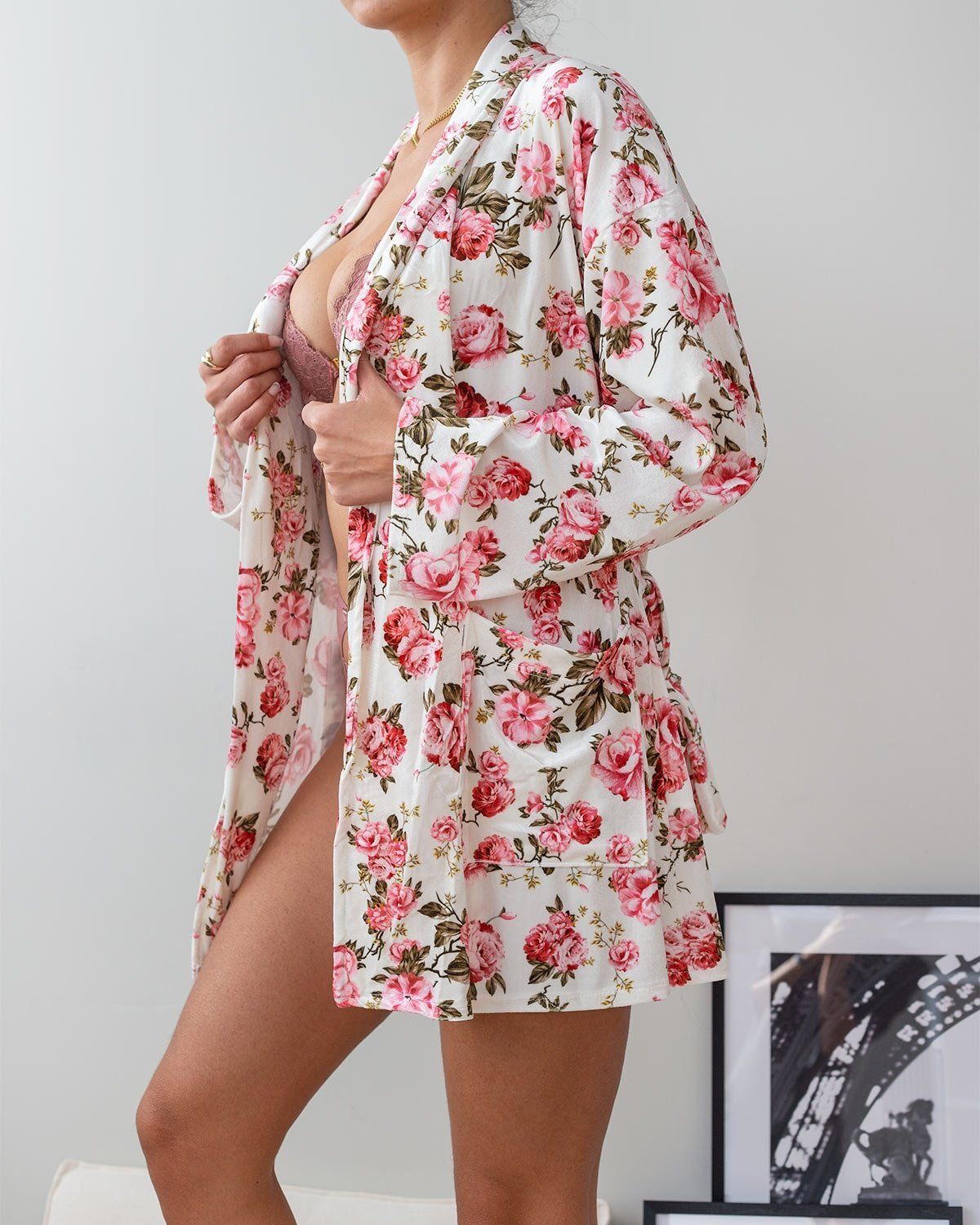 White velvet robe with pink and red rose floral print, open front, wide sleeves and fabric belt, worn on model, side view