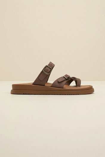Brown leather slide sandal with toe loop and two buckled straps on a thick tan sole, shown in side profile