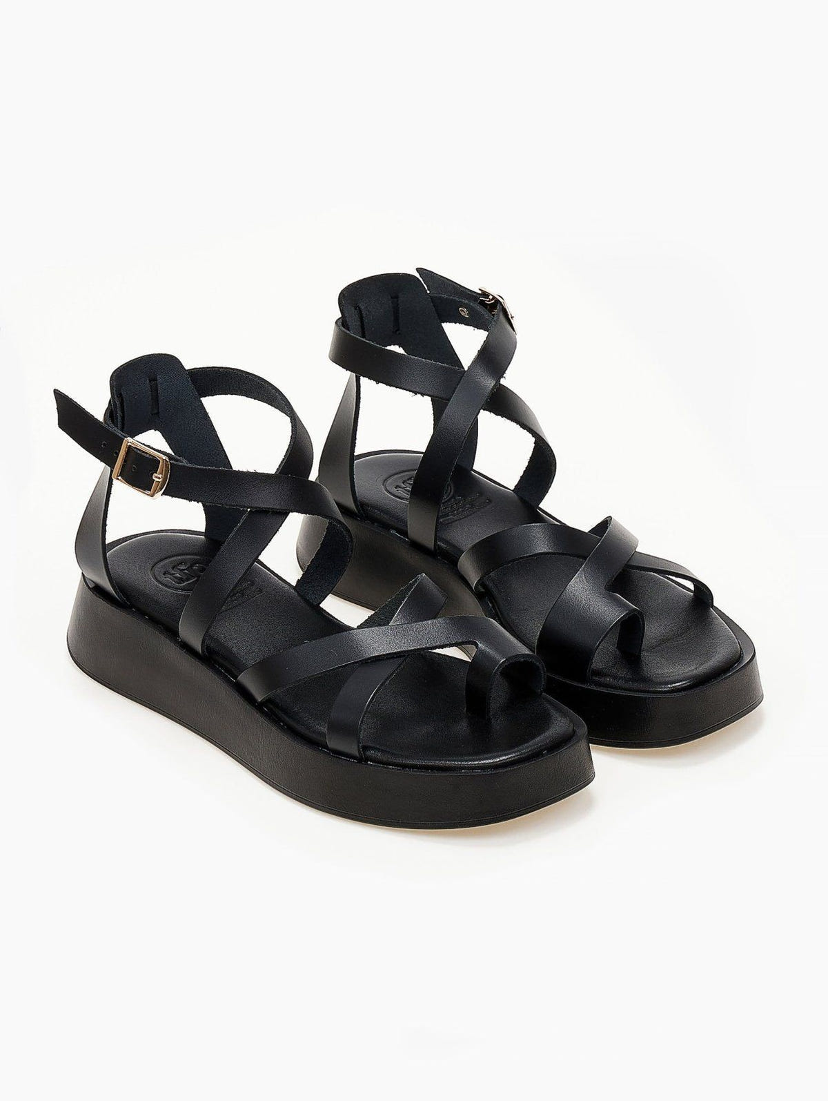 Black leather crossover strap platform sandals with toe loop and ankle buckle, three-quarter view