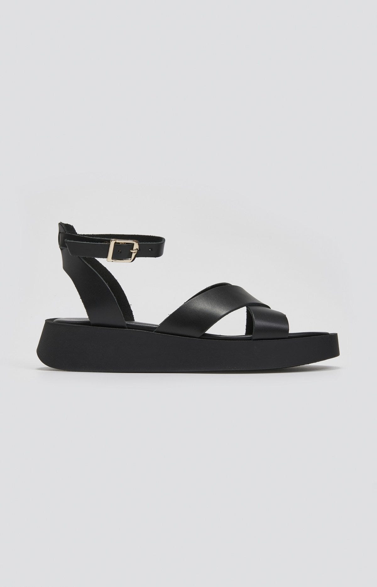 Black leather crossover strap platform sandal with ankle buckle strap, side view