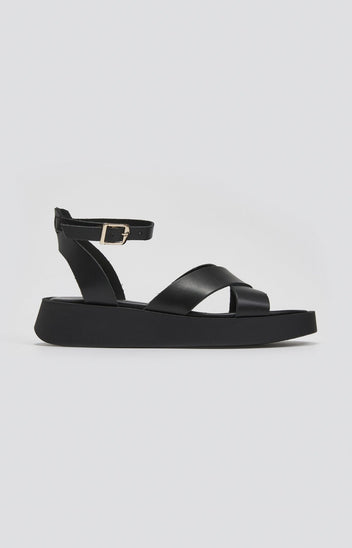 Black leather crossover strap platform sandal with ankle buckle strap, side view