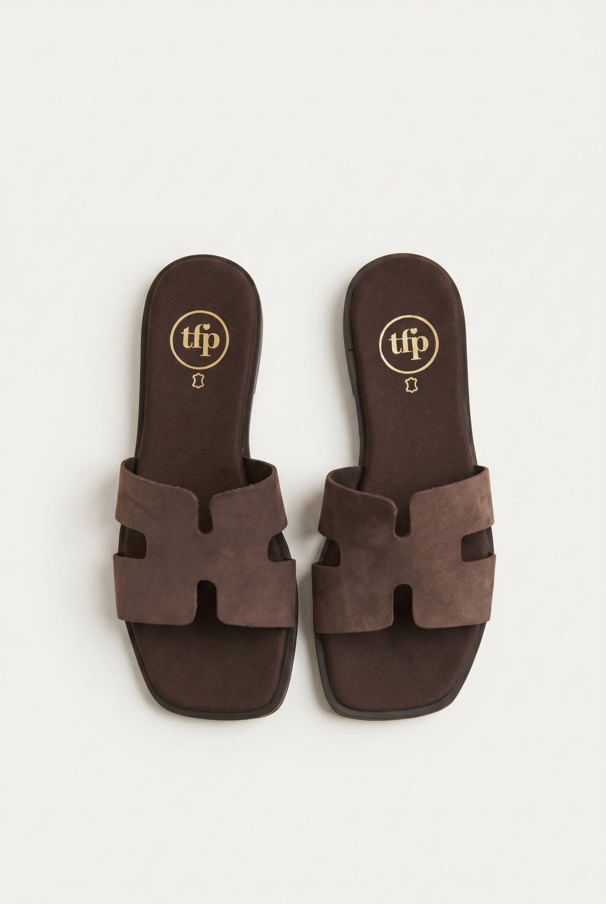 Pair of dark brown suede cut-out H strap flat slide sandals with square toe and leather insole, top view