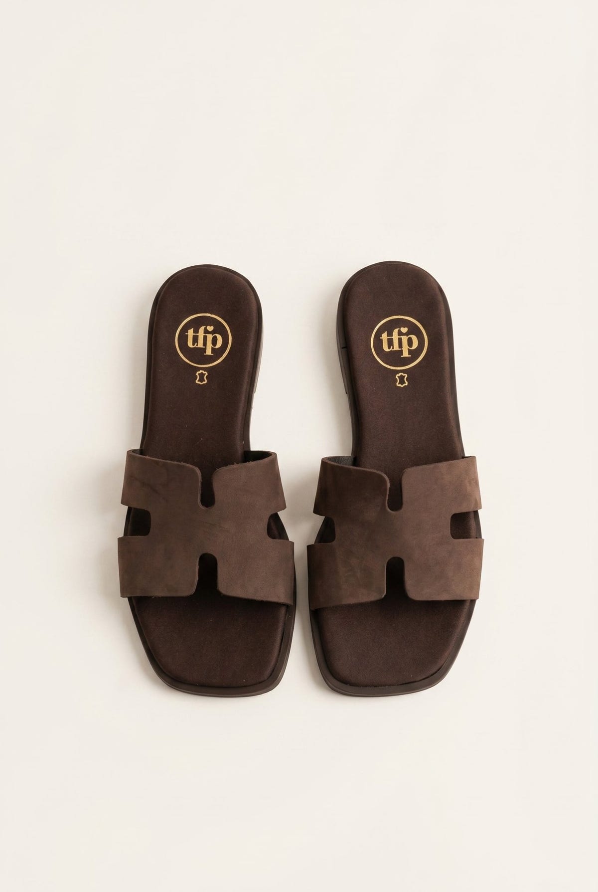 Pair of dark brown suede cut-out H strap flat slide sandals with square toe, top view