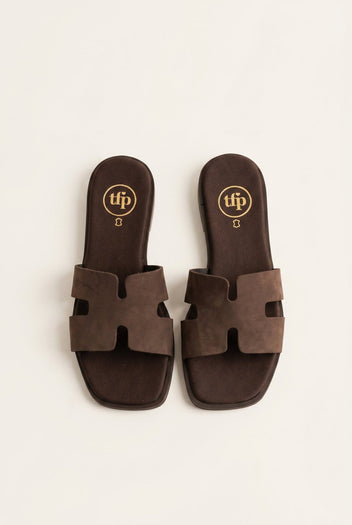 Pair of dark brown suede cut-out H strap flat slide sandals with square toe, top view
