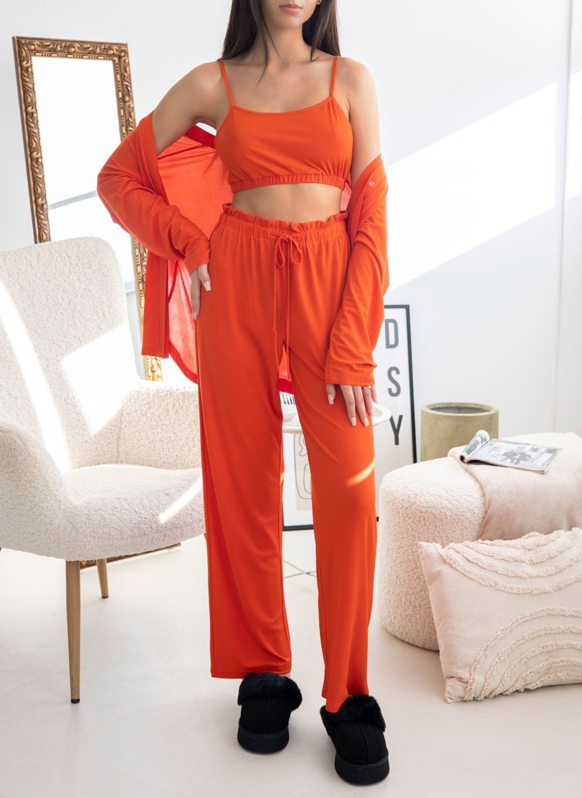 Orange ribbed pyjama set with camisole top, wide-leg drawstring trousers and long-sleeve shirt off the shoulders, worn on model, full length