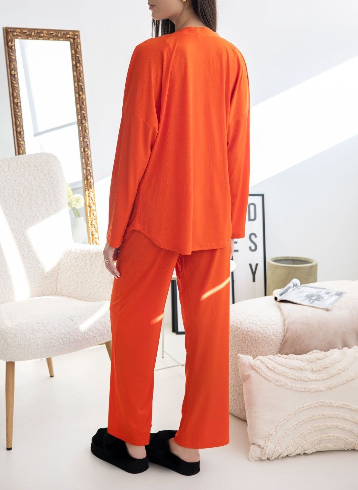 Orange ribbed pyjama set with long-sleeve shirt with curved hem and wide-leg trousers, worn on model, full length back view