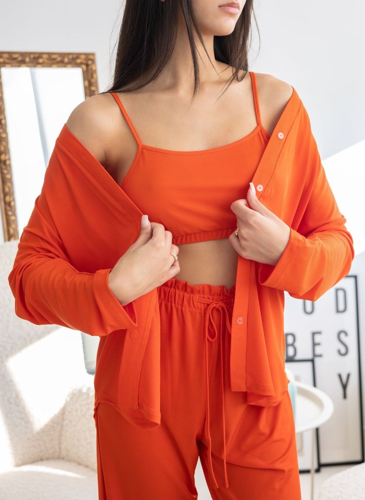 Orange ribbed pyjama set with button-front long-sleeve shirt, camisole top and drawstring waist, worn on model, close-up front