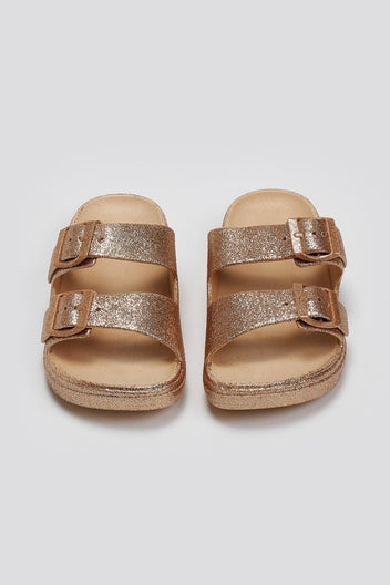 Pair of rose gold glitter double buckle slide sandals with beige footbed, top view