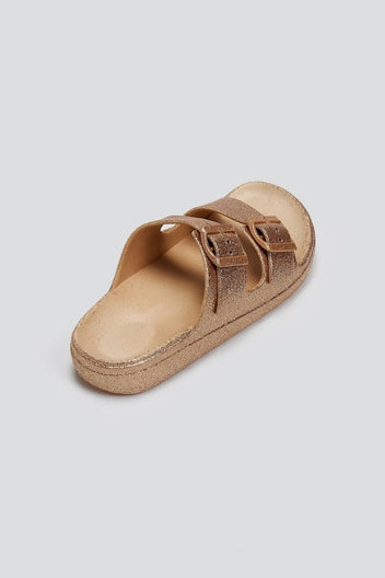 Rose gold glitter double buckle slide sandal with beige footbed, back three-quarter view