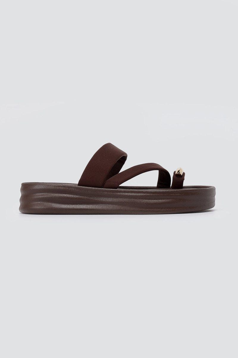 Single brown flatform toe ring sandal in side view with a thick ridged sole and a metal ring at the toe loop
