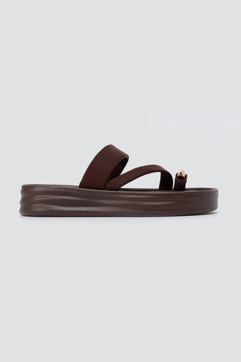 Single brown flatform toe ring sandal in side view with a thick ridged sole and a metal ring at the toe loop