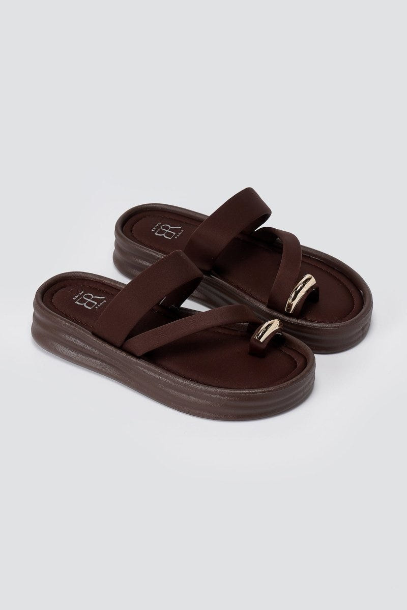 Pair of brown flatform toe ring sandals angled to show the chunky sole, padded straps and metal ring at the toe